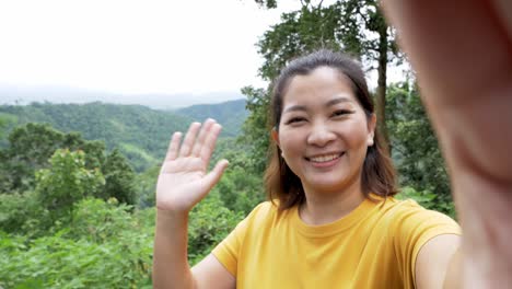 positive female hipster waving a hand at the camera during video chat online