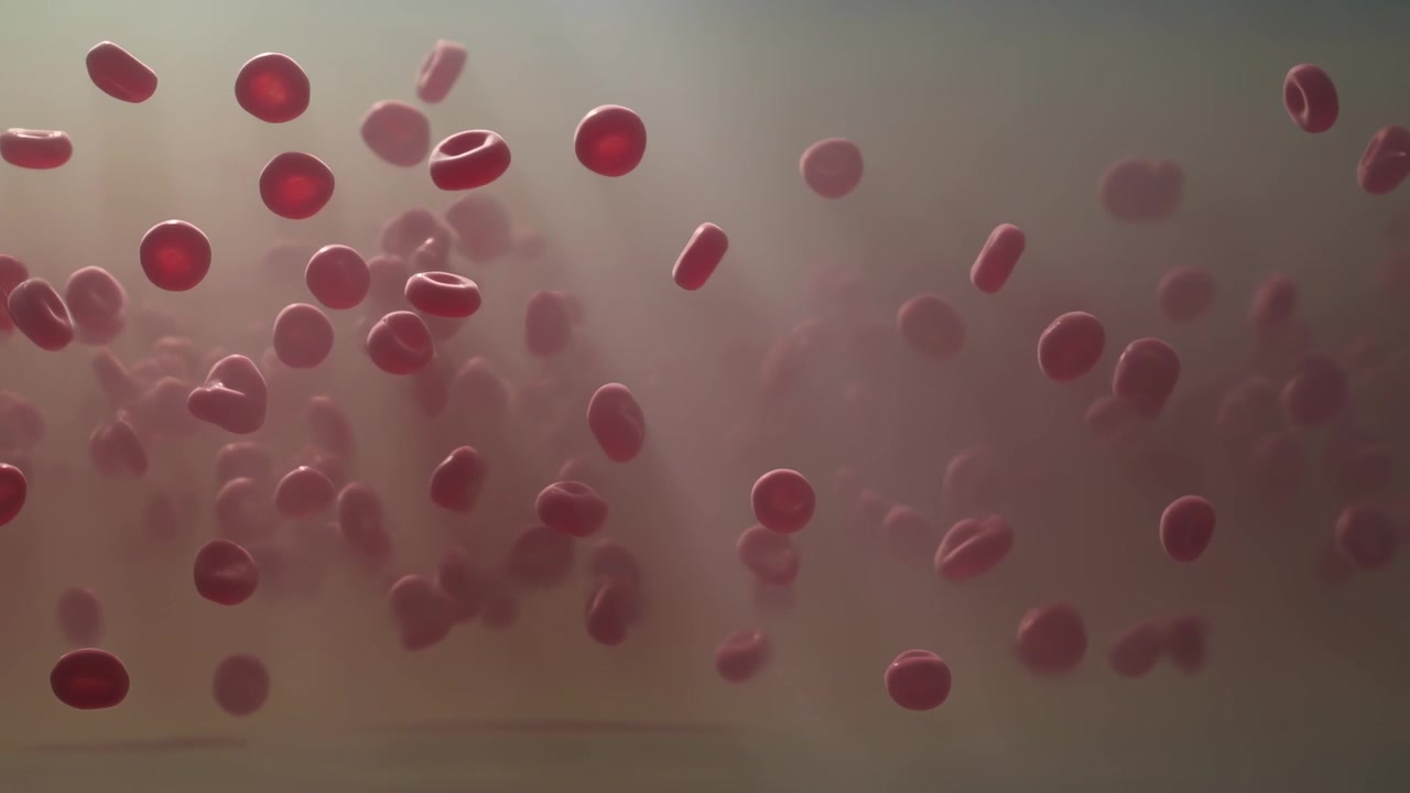 Drifting red discs rotating and dispersing in clear tank, agitation starting under soft light