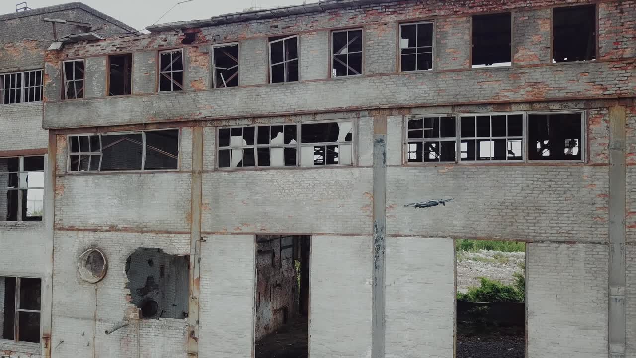 Aerial view of abandoned industrial buildings. Drone flies over an abandoned factory.