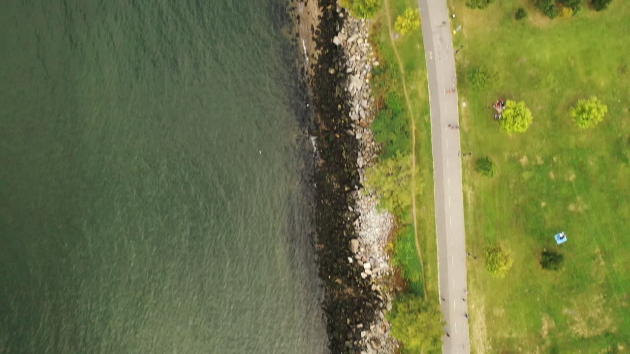 A top down shot over the stoney shores of the East River near the Throgs Neck Bridge