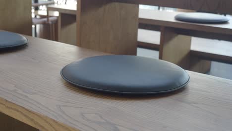 modern wooden bench seating with round cushions