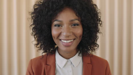 close-up-portrait-of-stylish-young-african-american-woman-afro-hairstyle-laughing-happy-looking-at-camera-trendy-black-female-wearing-suit