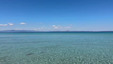 stunning beach scene in halkidiki, greece, with elegant sunbeds facing the crystal-clear turquoise sea. a perfect summer escape in the heart of the aegean.