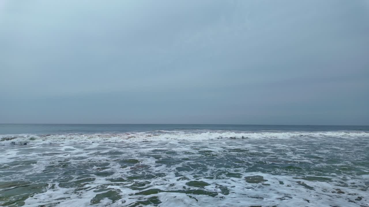 Amidst sea waves on cloudy day. Static, slomo