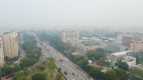 aerial drone shot capturing the urban energy of delhi as vehicles navigate through a multi-layered network of flyovers and roads.