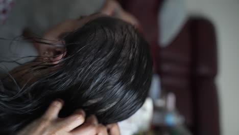 Close-Up-View-Of-Back-Head-Of-Female-Getting-Oil-Massaged-Into-Her-Hair-And-Scalp