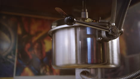 popcorn pour out of popcorn machine. worker control popcorn production process