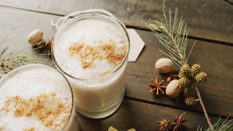 Video-of-cups-of-hot-chocolate-with-cinnamon-over-wooden-background