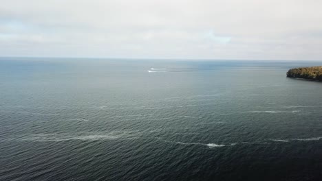 boats on a vast lake with distant coastline