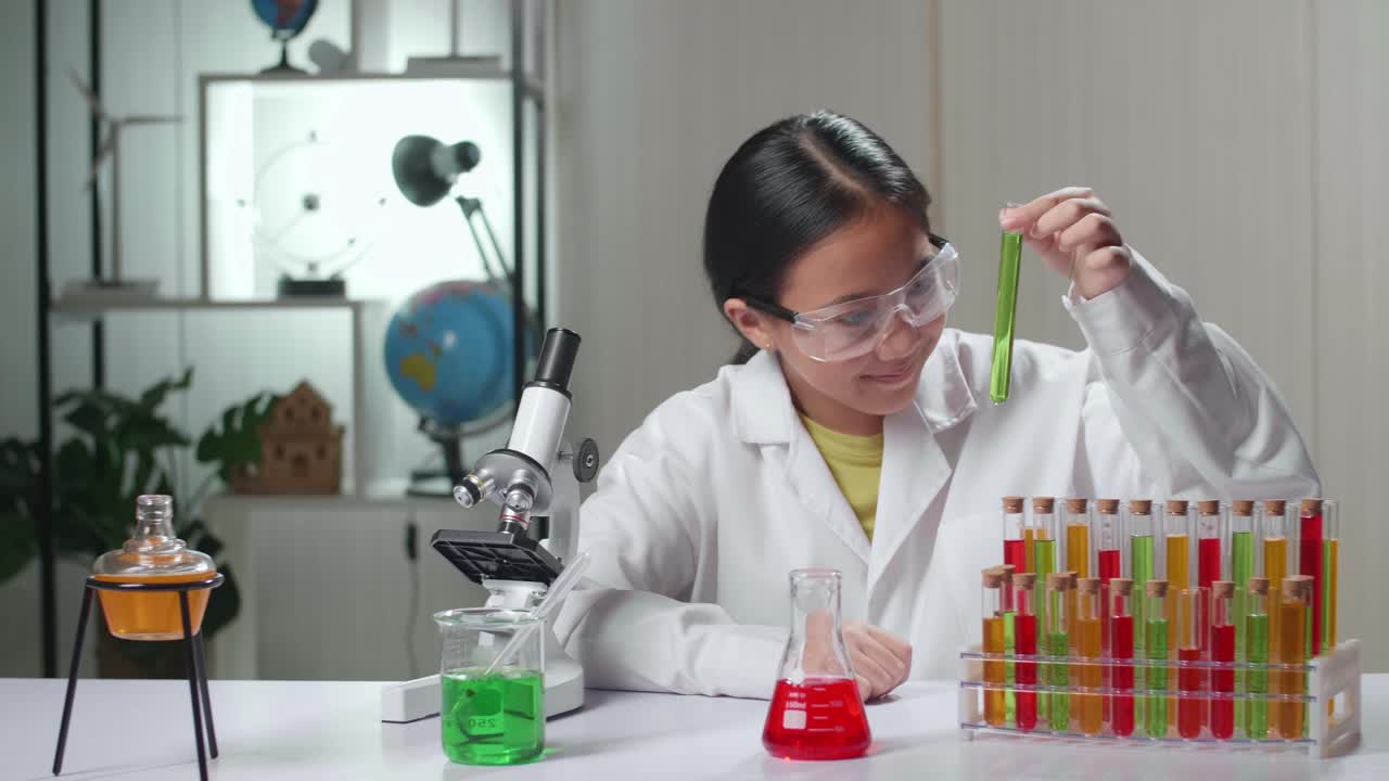 Young Scientist Girl Looking At Liquid In Test Tube