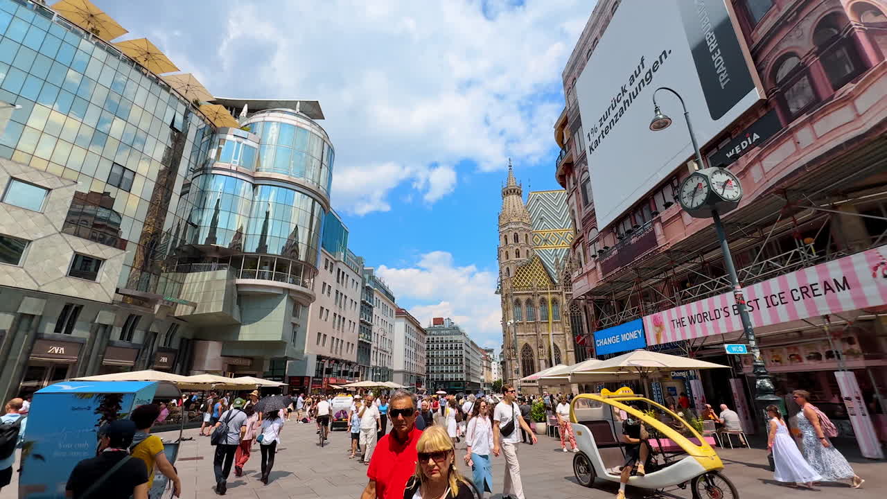 Vienna, Austria - June 9, 2025: Many people walk by the street leading to Saint Stephen's Cathedral. An old town in Vienna, Austria
