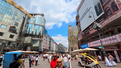 vienna, austria - june 9, 2025: many people walk by the street leading to saint stephen's cathedral. an old town in vienna, austria
