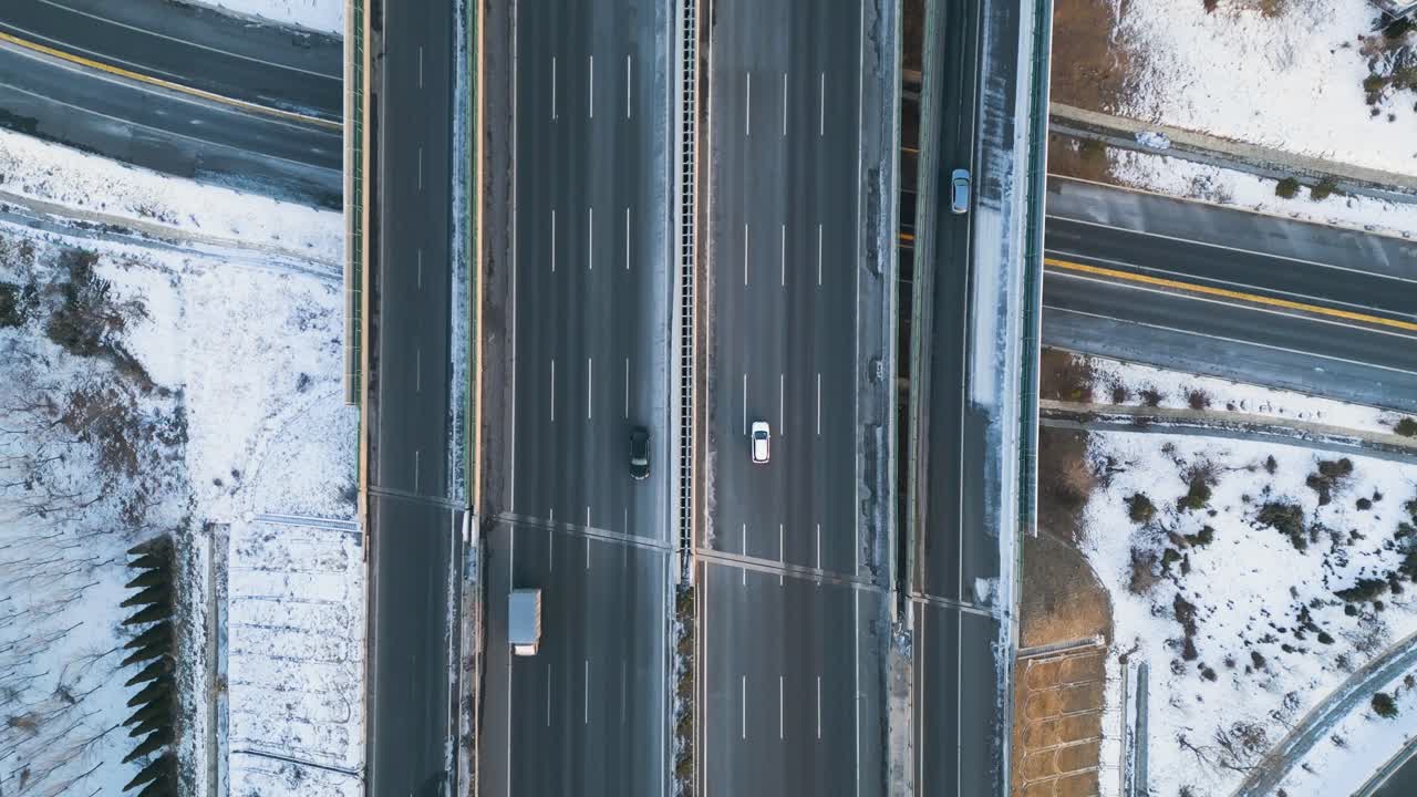 expressway topview, chinese infrastructure aerial view, cars driving the highway, snow roads in winter Shandong province, Qingdao-Yinchuan