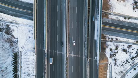 expressway topview, chinese infrastructure aerial view, cars driving the highway, snow roads in winter shandong province, qingdao-yinchuan