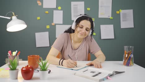 happy female student listening to music.