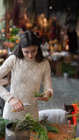 woman arranging floral decorations