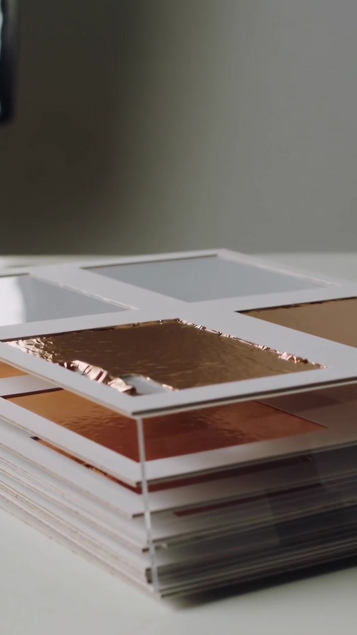 Vertical video: Lifting camera revealing stacked samples on table, showing copper foil and spacers