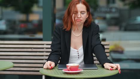 woman working at an outdoor cafe