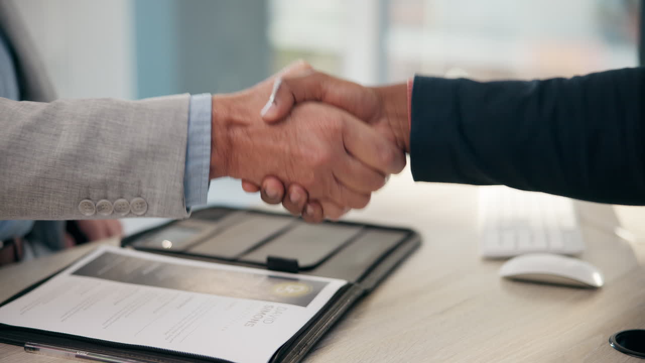 A handshake between two professionals during a job interview