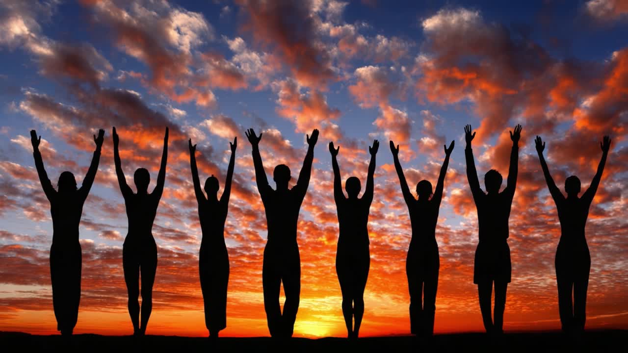 Silhouetted Figures Celebrating Against a Dramatic Sunset Sky with Vibrant Colors, Expression of Joy, Unity, and Exultation Captured in This Scenic Moment
