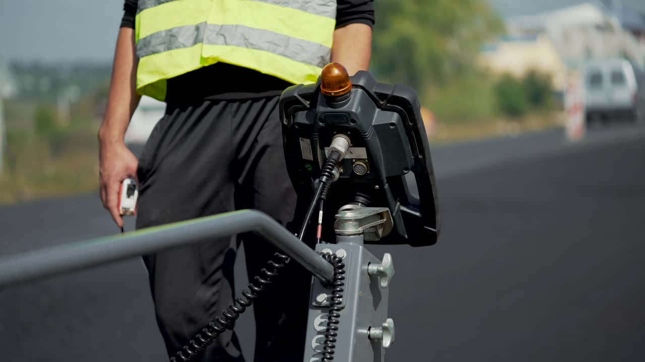 Worker on road construction. Worker in reflective vest repairing highway during roadworks