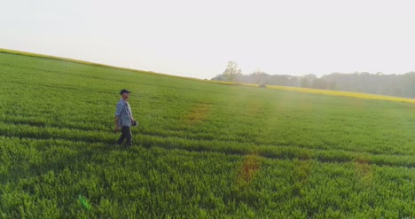 Agriculture-Male-Farmer-Walking-On-Track-Over-Agricultural-Field-While-Using-Digital-Tablet-14