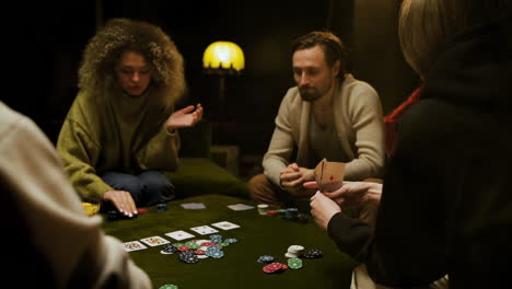 group of friends playing poker sitting on the couch in the living room 11