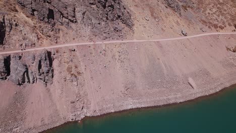 Tourists-Walking-At-The-Unpaved-Road-In-Andes-Mountain-By-El-Yeso-Dam-In-Chile