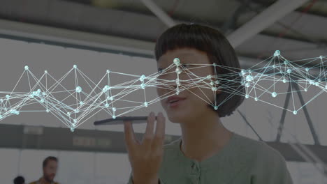 woman speaking into smartphone with digital network connections overlay animation