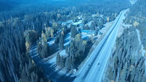 Manning-Park-main-entrance-aerial-birds-top-view-overlooking-property-divide-between-highway-staff-building-to-commercial-rental-chalets,-cabins,-hotel,-banquet-halls,-pubs-and-restaurants-onsite-1-3