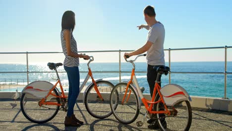 couple interacting with each other near railing 4k