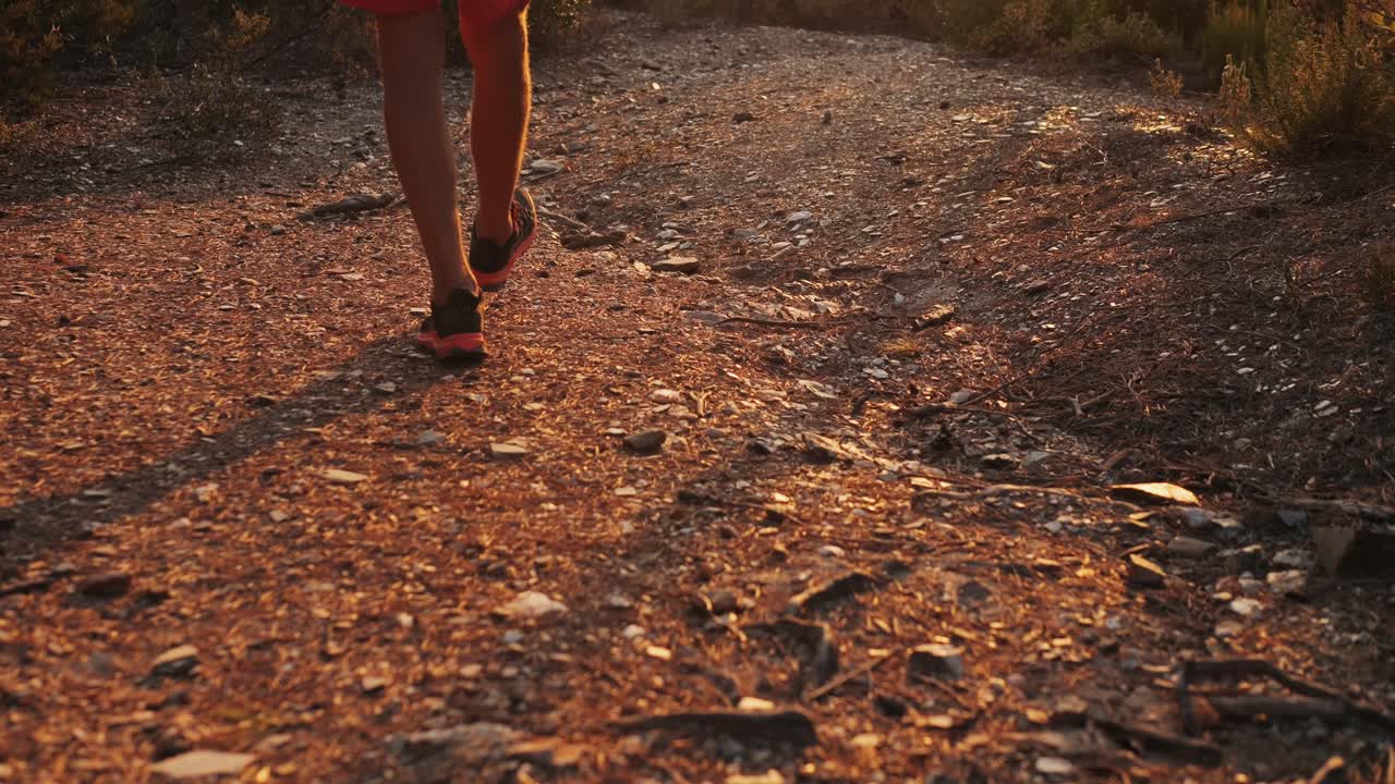 Person Hiking on a Trail at Sunset