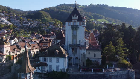 toma aérea de primer plano sobre el castillo de oberhofen en suiza en un día soleado