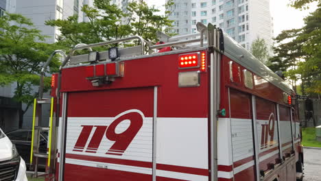 rear of 119 firetruck in south korea, equipped with ladder and flashing emergency lights