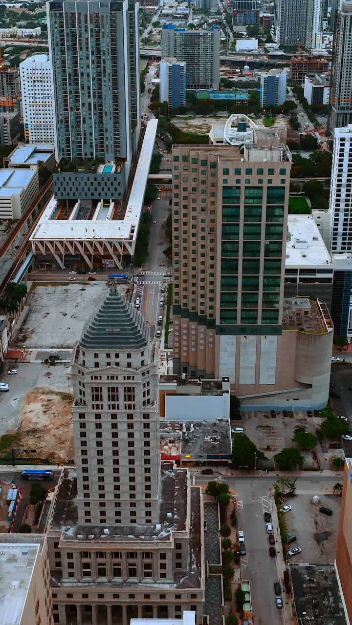Flight above the diverse beautiful buildings in Miami cityscape. Drone footage of metropolis at daytime. Vertical video