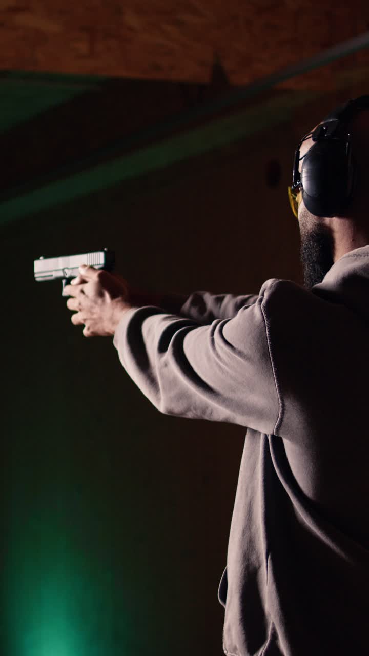 Vertical video Gun enthusiast reloading handgun, pointing weapon