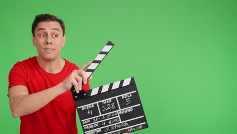 Filmmaker using clapperboard on green screen background
