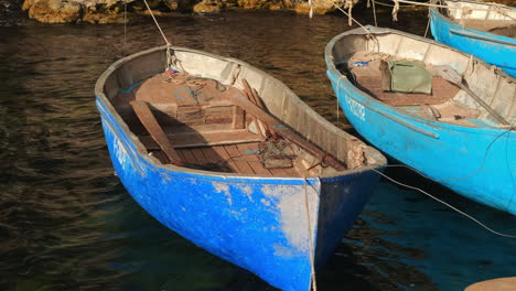 old blue fishing boats at a coastal harbor