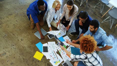 team of executives discussing over document in the meeting