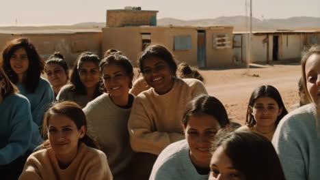 a group of women smiling in a desert setting