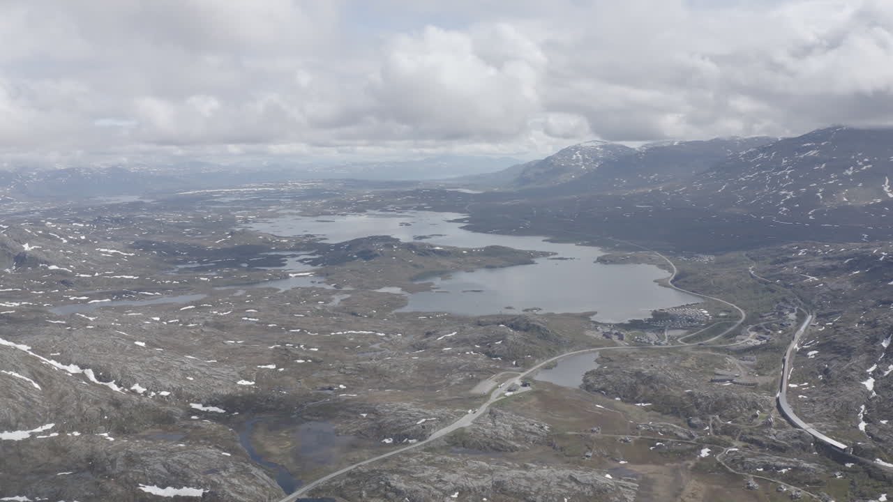 Aerial drone shot of the nordic rocky landscape of the town of Bjørnfjell at the Swedish border.
High view of the arctic tundra and vast wilderness.