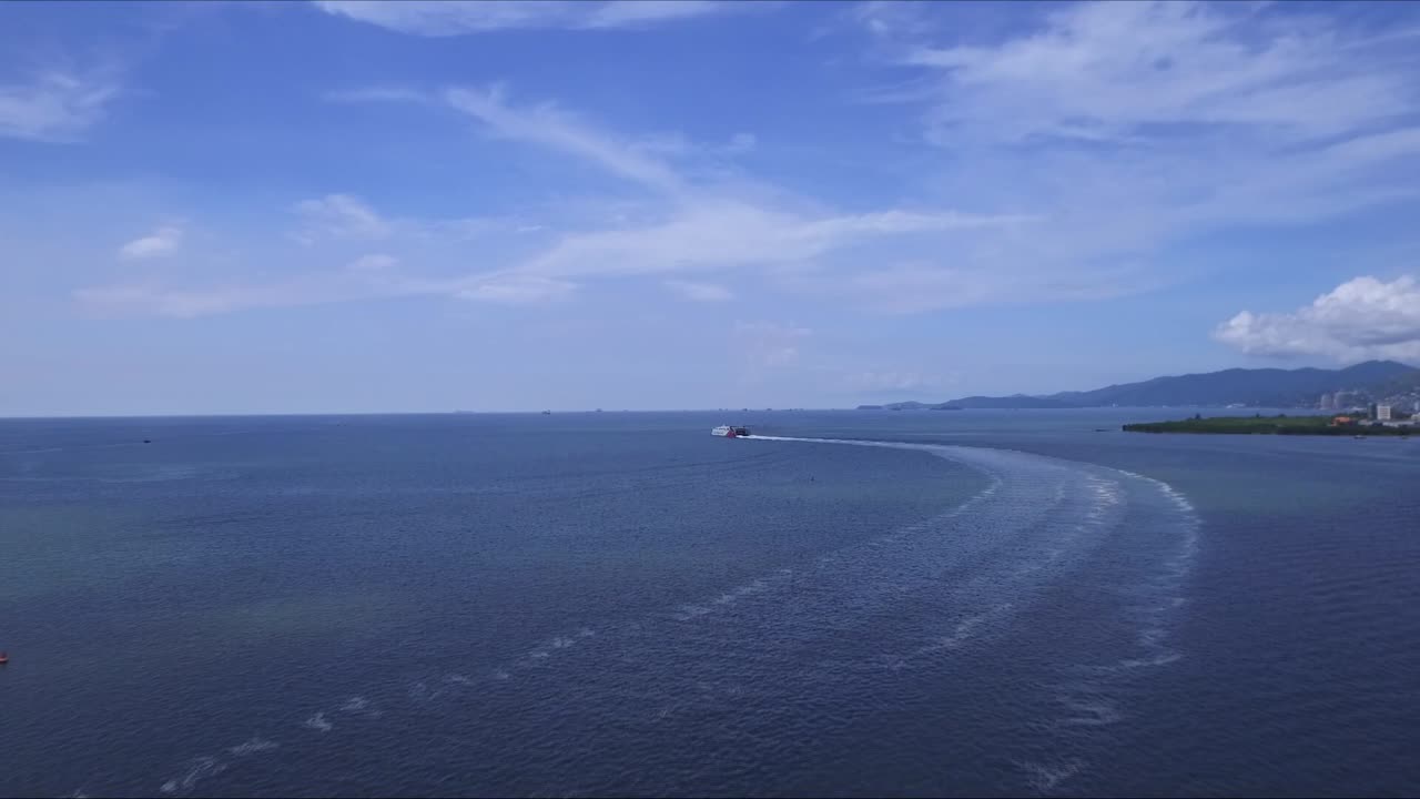 An aerial view of a ferry leaving its port in trinidad adnd tobago
