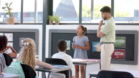 young asian man teaches in a modern classroom at school
