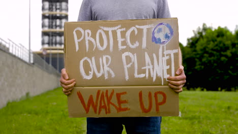 close up of a handsome man holding a placard