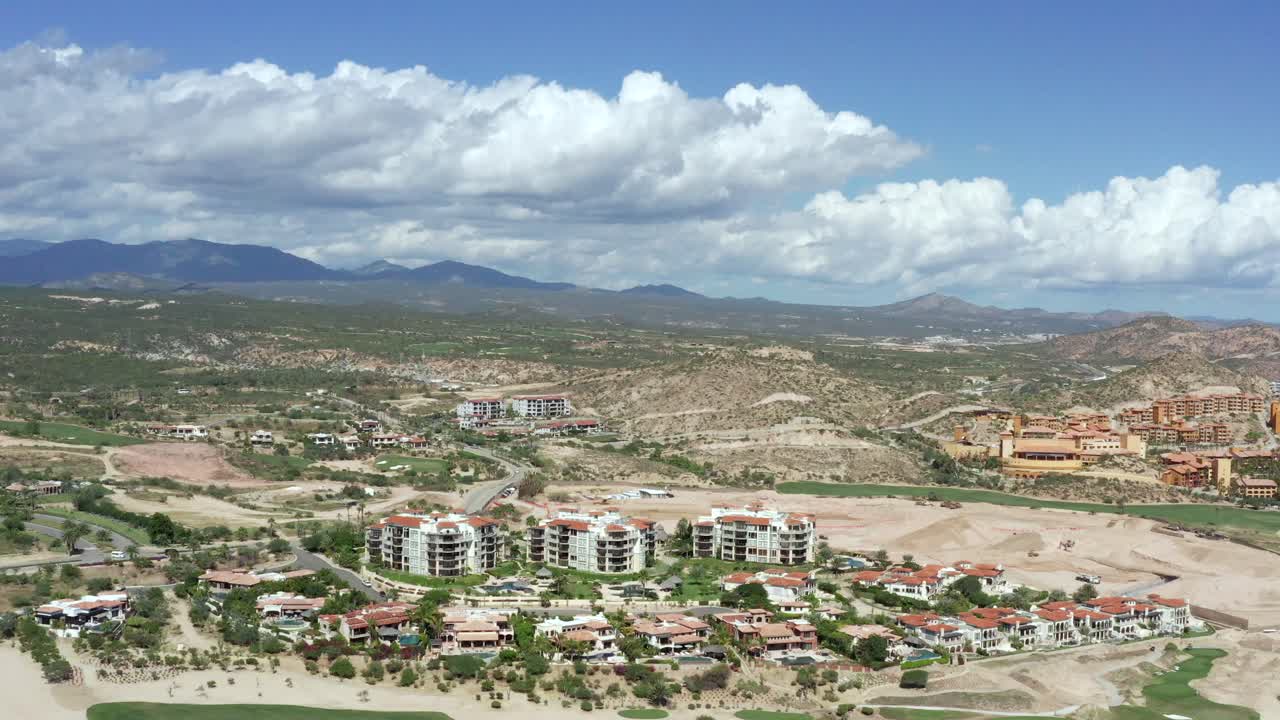 Aerial, drone shot, overlooking resorts, at the hotel area, in Cabo San Lucas, on a sunny day, in Baja California sur, Mexico