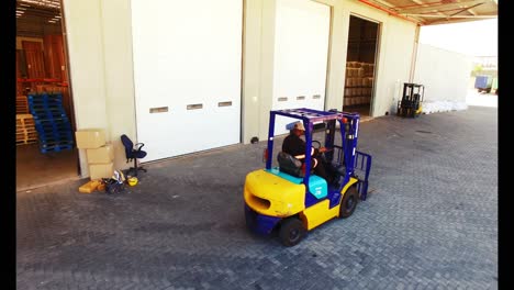 warehouse worker driving forklift