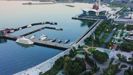 Azerbaijan-capital-city-aerial-–-National-flag-square-of-Baku,-Caspian-embankment-and-city-harbor