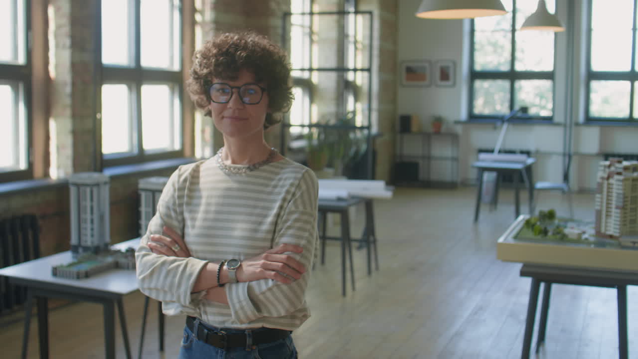 Female Architect Standing in Her Studio with Architectural Models