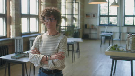 female architect standing in her studio with architectural models