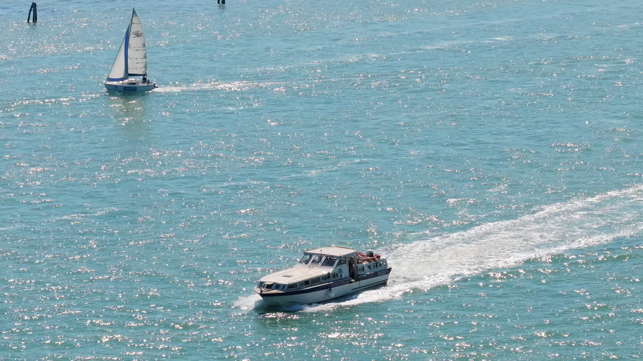 Aerial drone shot of a boats sailing on the sea at daytime in Venice, Italy